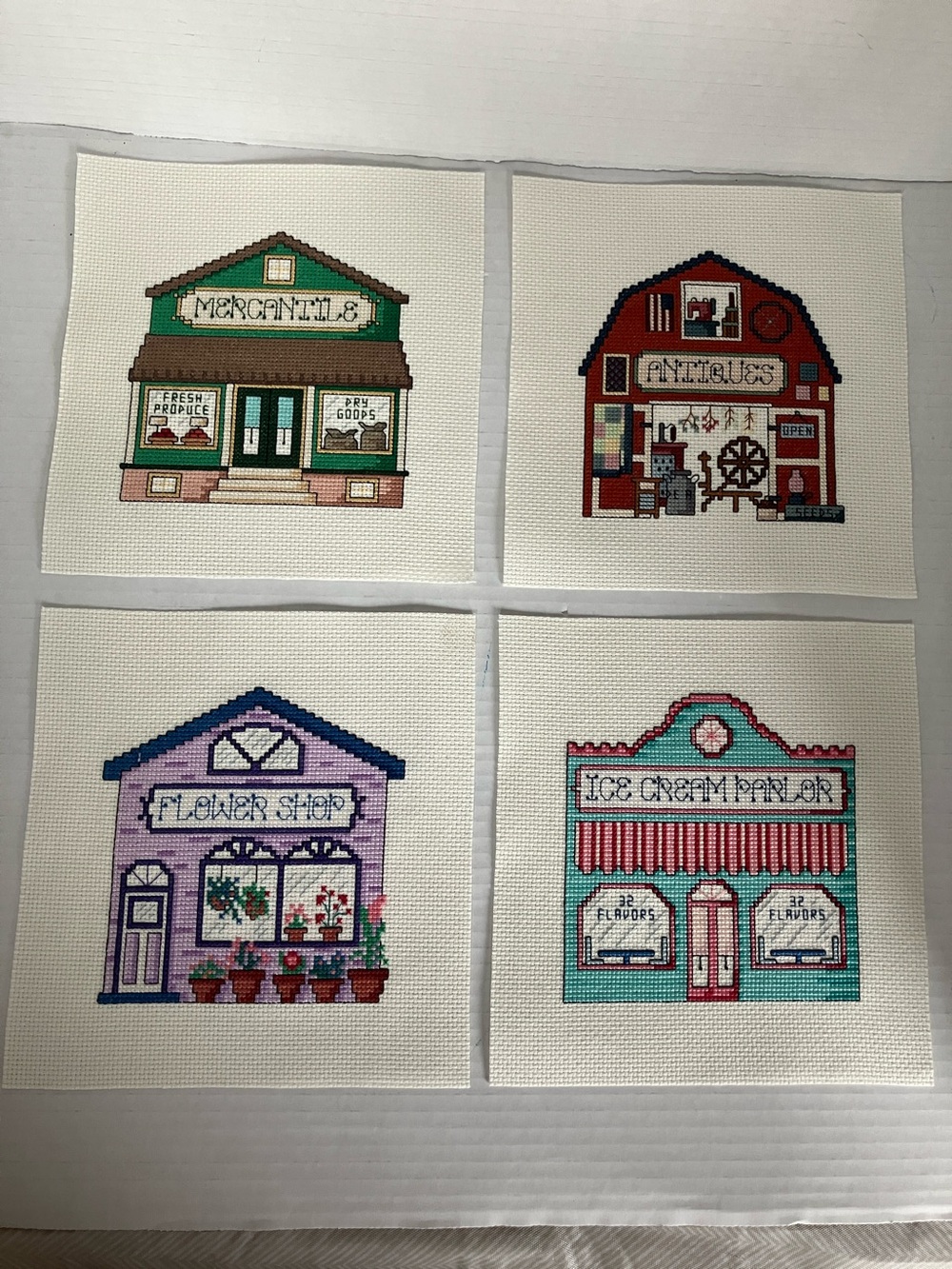 Hand Crafted Village Cross-Stitch 4 piece Set Mercantile Antique Flower Parlor